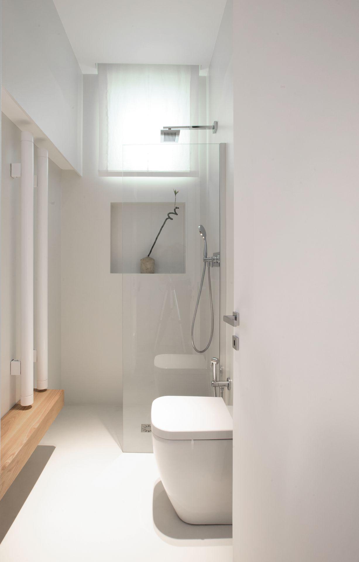 Prosjekt for interi&oslash;r og eksteri&oslash;r av Ernesto Fusco p&aring; Amalfikysten. Bad med bl&aring; og hvite keramiske fliser, i hvit resin, minimalistisk servant og innebygde nisjer i tre.