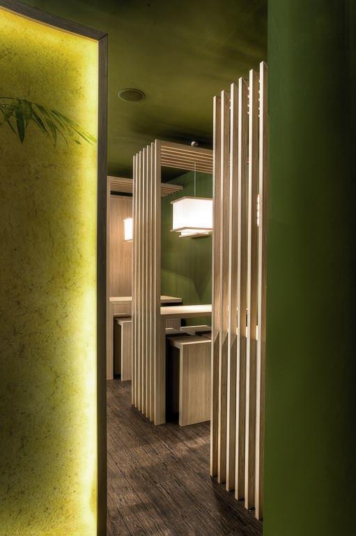 Enkelt dekket sitteplass ved disken med fokus p&aring; h&aring;ndverk, materialer og n&aelig;rhet til sushi-tilberedningen.